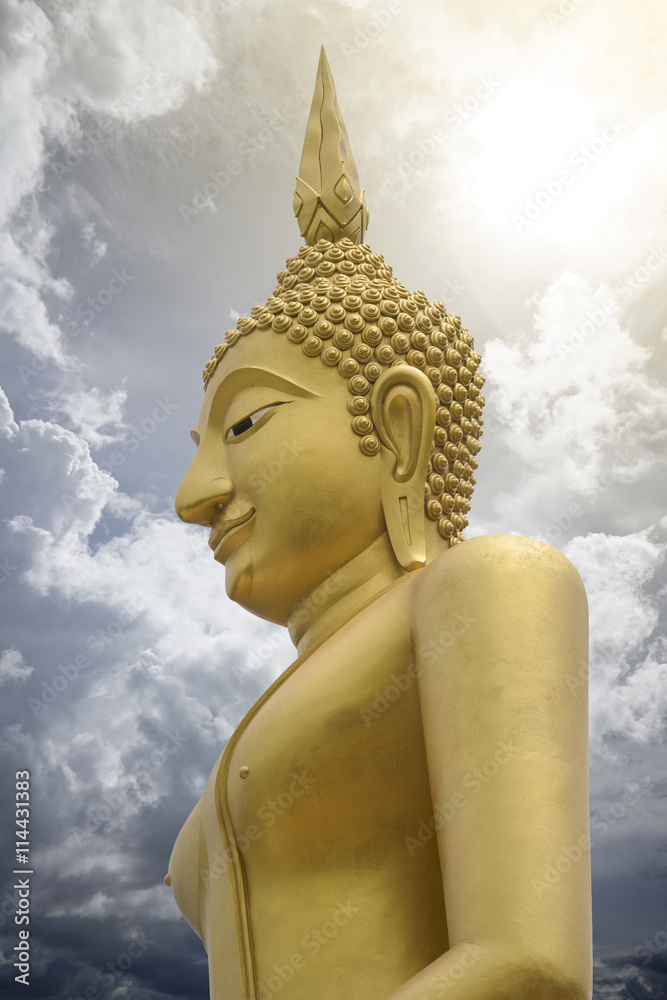Gold image of Buddha with blue sky and cloud in background, light ...