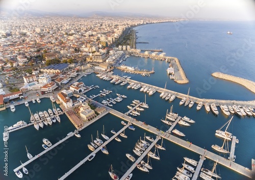 Aerial view of the beautiful Marina in Limassol city in Cyprus,beach,boats,piers,villas, commercial area,old port (palio limani) and Molos. A modern,high end,newly developed space with docked yachts. 