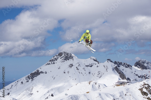 Ski rider jumping on mountains. Extreme ski freeride sport.