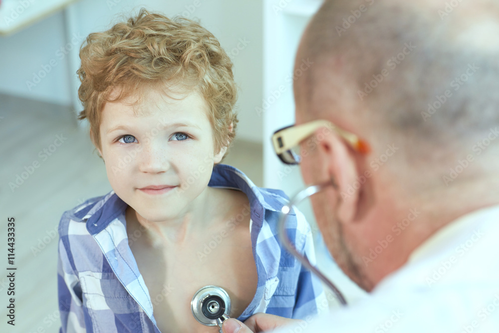 Doctor examining a child patient teeth by orthodontic tools. Doctor examining a child patient teeth by orthodontic tools.