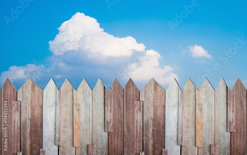 Wooden wall and cloudy sky