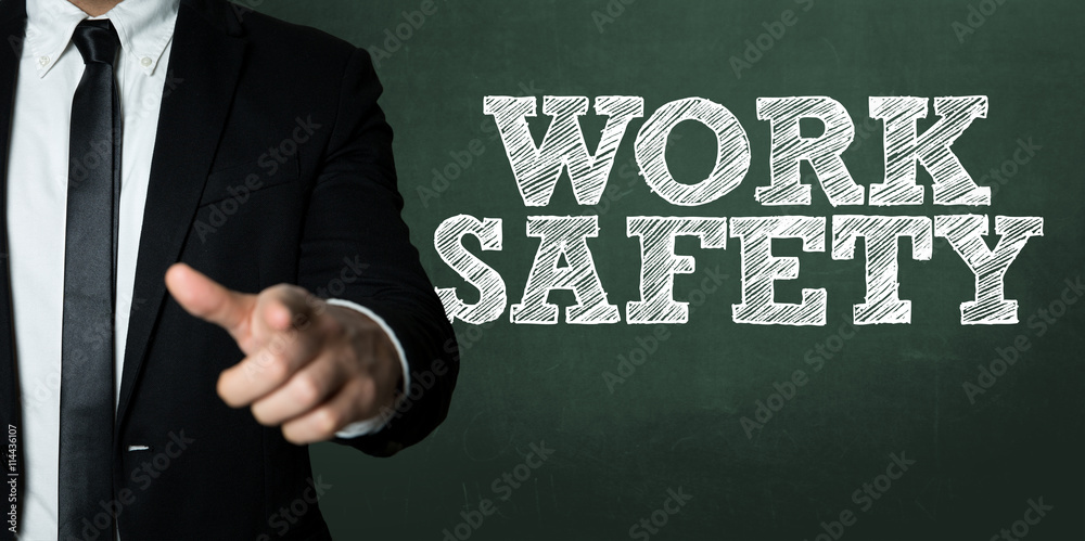 Business man pointing with the text: Work Safety Business man pointing with the text: Work Safety