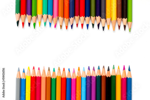 Row of color pencil placed on white background