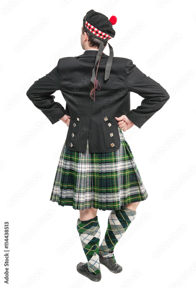 Scottish man in traditional national costume back posing