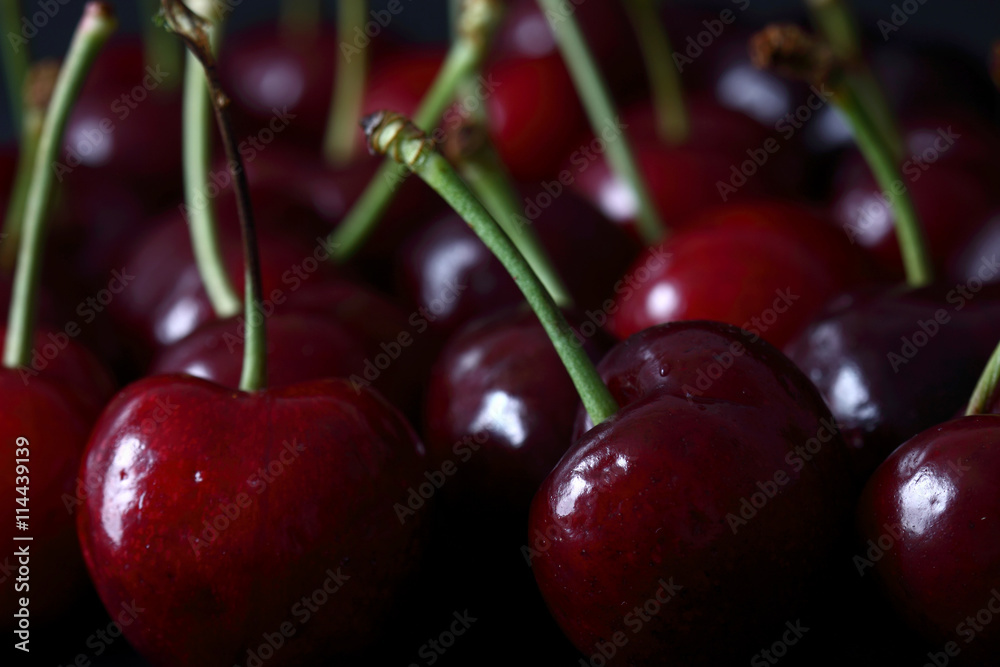 Cherries / Fresh cherries on a black wood background Cherries / Fresh cherries on a black wood background