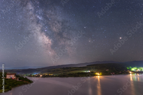 Milky way over lake Cincis in Romania with Mars and Saturn