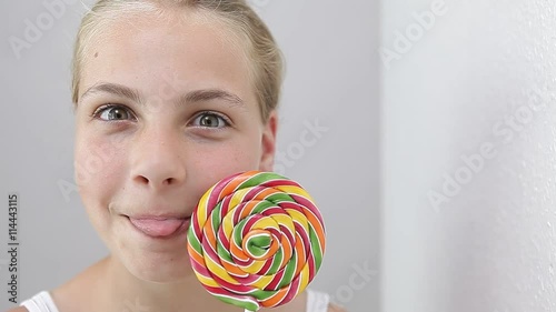 girl holding lollipop and making funny face