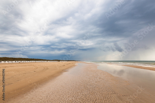 Beach at Lokken in Denmark with dark storm clouds