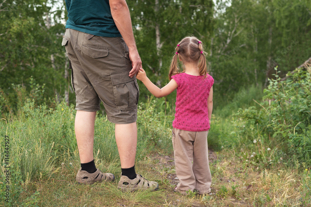 Father and daughter walking on a hill Father and daughter walking on a hill