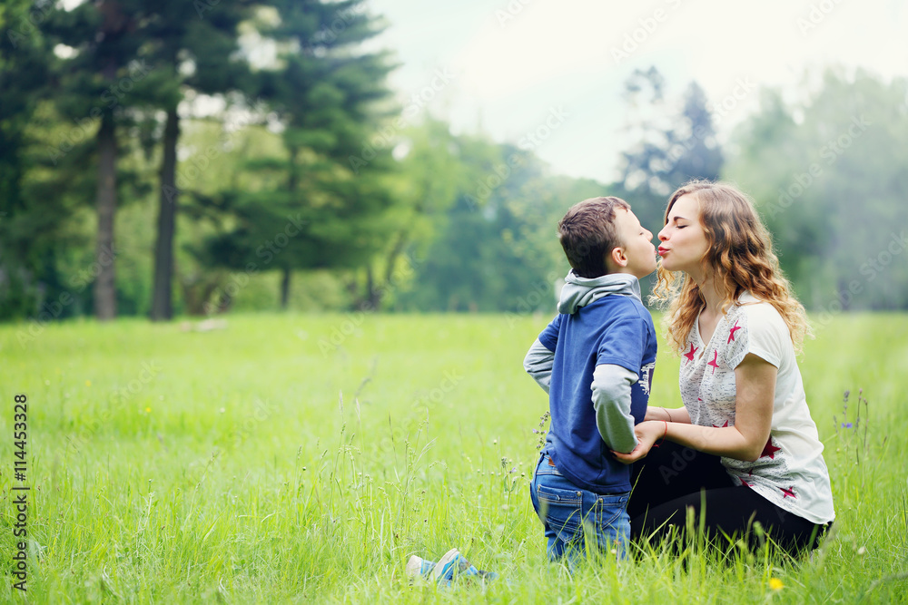 Mom kissing son