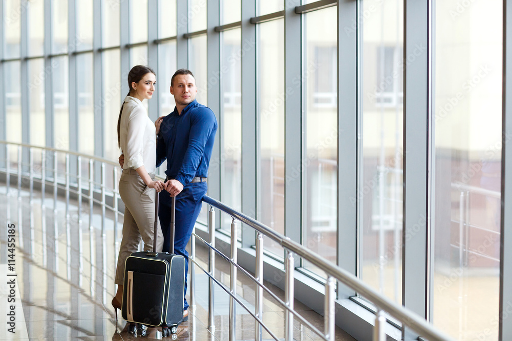 Couple in love on vacation. Couple standing in the airport. Couple in love on vacation. Couple standing in the airport.