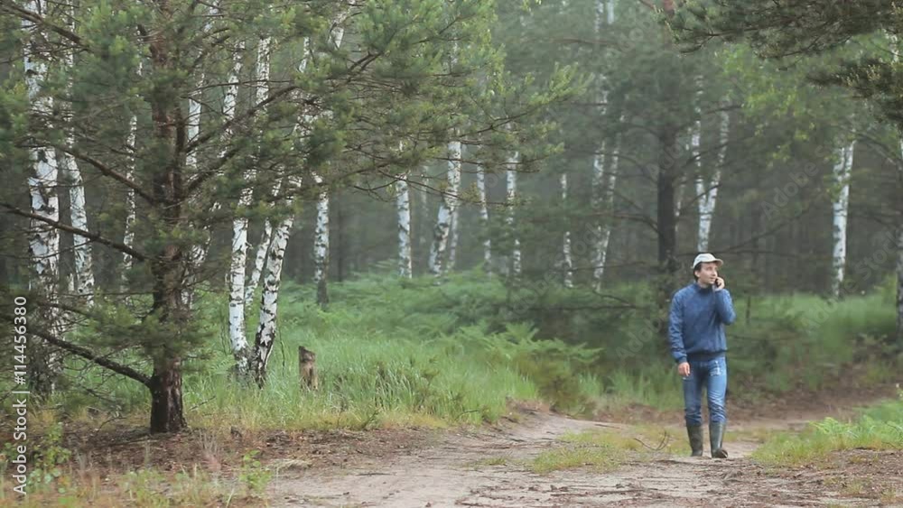A man walks through the forest and call by phone Early morning A man walks through the forest and call by phone Early morning