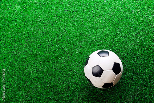 Soccer ball against artificial turf. Studio shot. Copy space. © Halfpoint