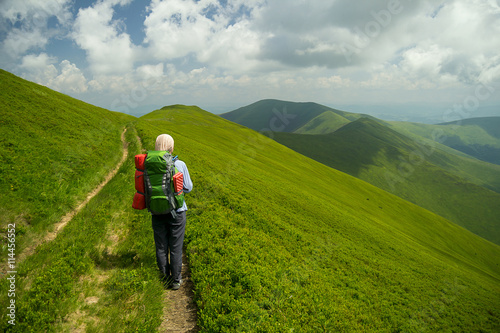 Young woman whit backpack in mountains