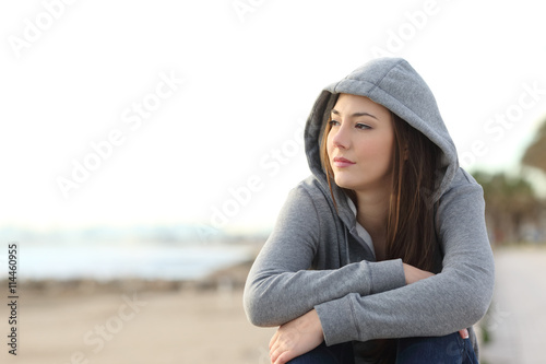 Longing pensive teenager looking away photo