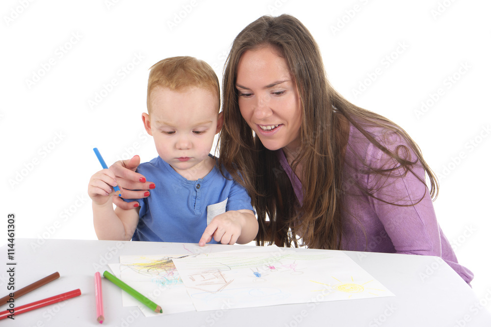 Mother and son are drawing the picture together Mother and son are drawing the picture together
