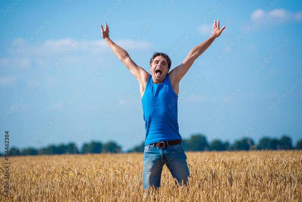 Young happy man in a wheat field. Young happy man in a wheat field.