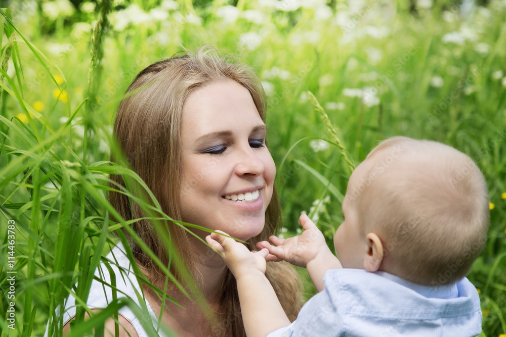 Happy mother with her son in a meadow Happy mother with her son in a meadow