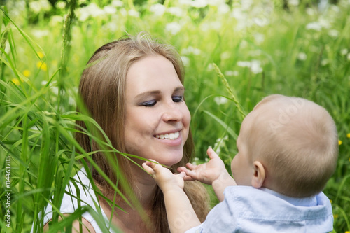 Happy mother with her son in a meadow