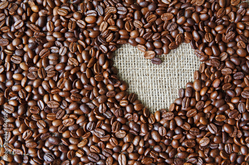 Coffee beans background with burlap heart frame