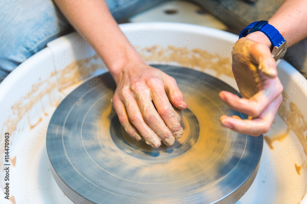 Pottering - creating a clay cup in process Pottering - creating a clay cup in process