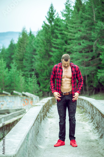 Handsome man wearing checked shirt outdoors