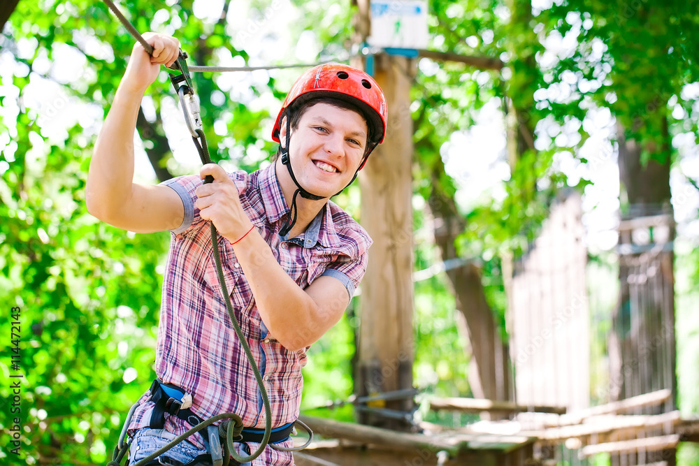 Fototapeta premium adventure climbing high wire park - people on course in mountain