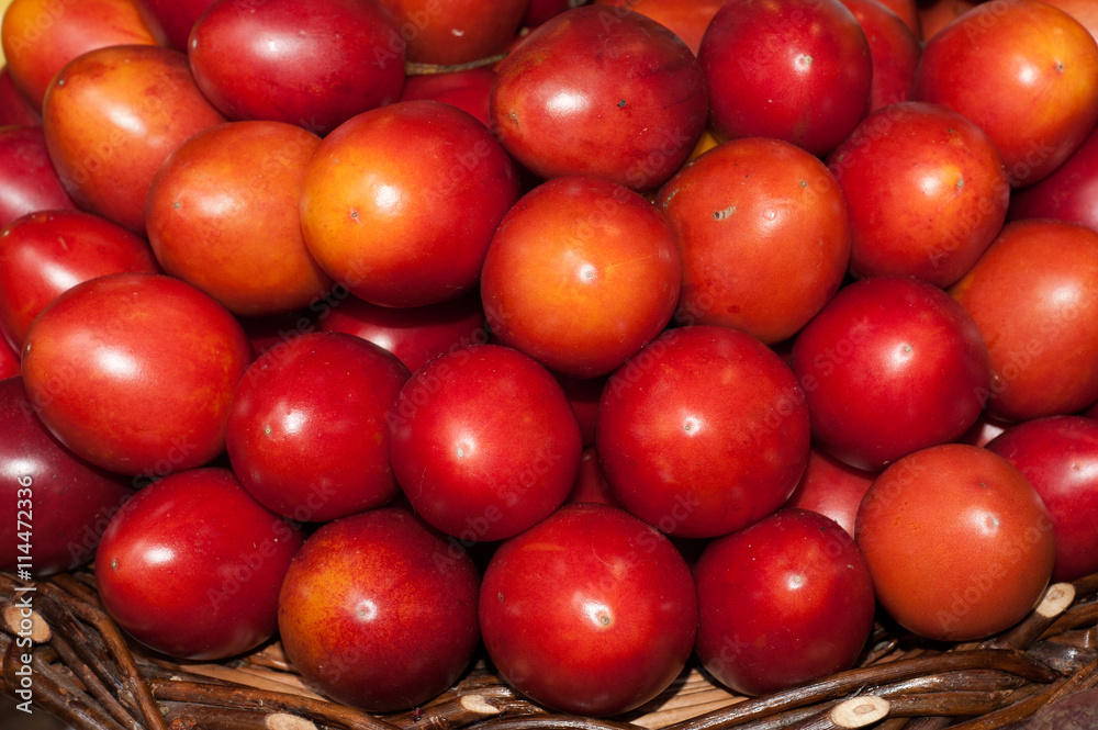Ripe fresh tamarillo (english tomato, tamarilho) in basket. Ripe fresh tamarillo (english tomato, tamarilho) in basket.