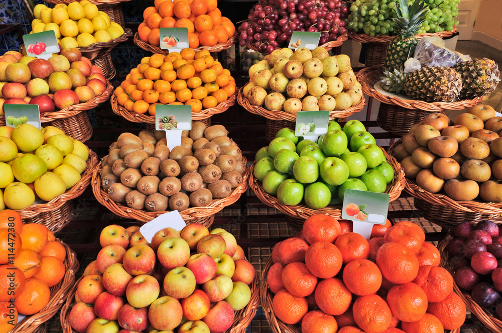 Fresh ripe exotic tropical fruits on shelves in Mercado dos Lavradores, Funchal, Madeira island, Portugal.