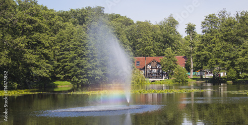 beautiful fountain and rainbow on a lake
