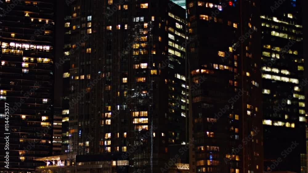 Video 4k - Static shot of several commercial office highrise buildings in the downtown area of a major, metropolitan city at night.