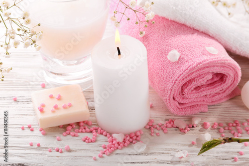 Spa composition with blooming branches on wooden table