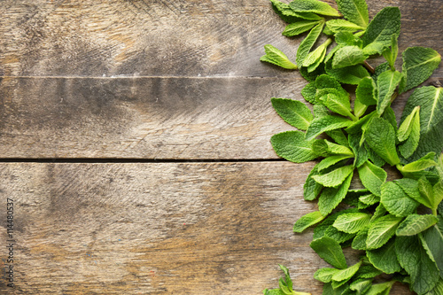 Fresh mint leaves on wooden background