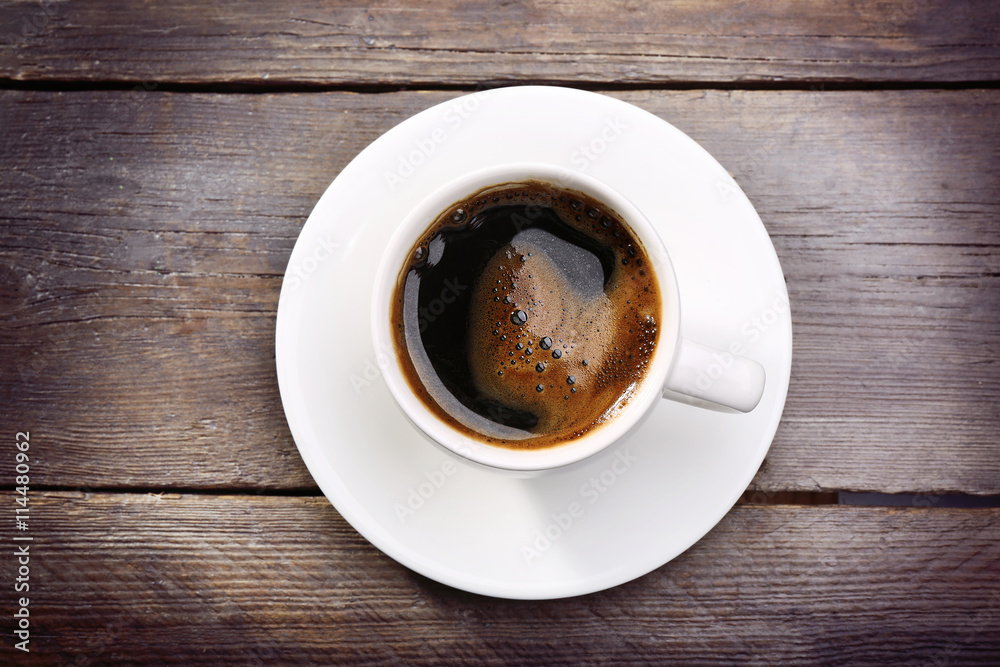 Cup of fresh coffee on wooden background
