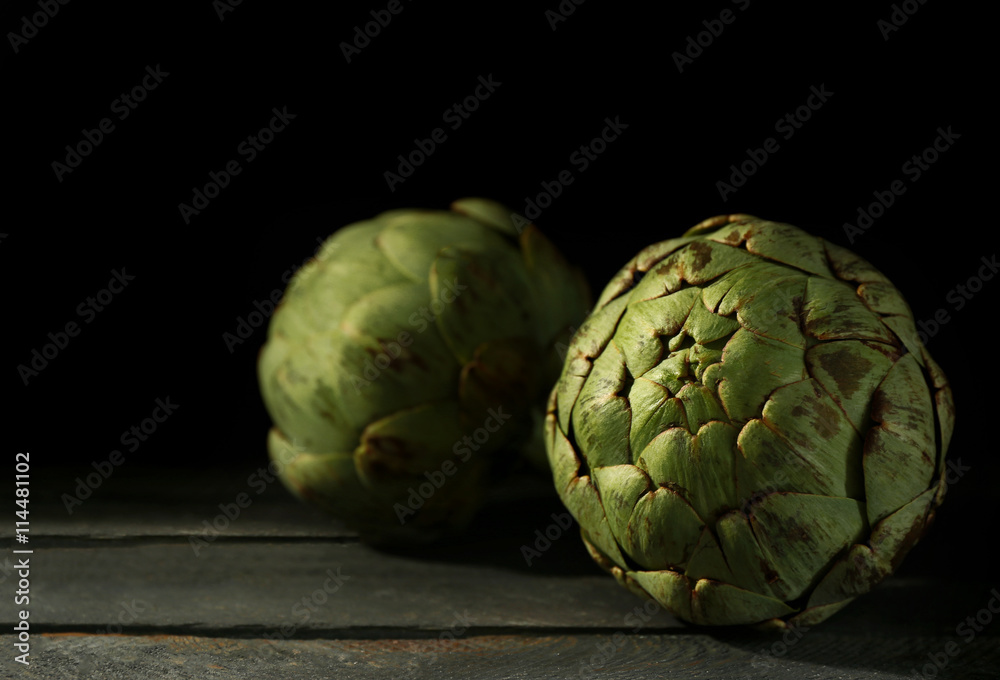 Fototapeta premium Artichokes on wooden background