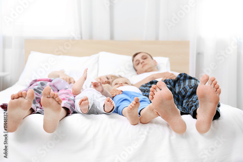Happy family on white bed i...