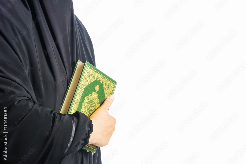 Koran in hand - holy book of Muslims women ( public item of all muslims ) Koran in hand - holy book of Muslims women ( public item of all muslims )