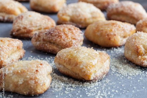 Rows of cottage cheese cookies covered in sugar. Shallow depth of field