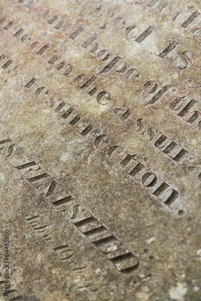 Fototapeta premium Grungy Abstract Hand carved typeset on an old english gravestone, with a shallow depth of field
