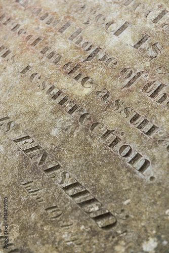 Grungy Abstract Hand carved typeset on an old english gravestone, with a shallow depth of field