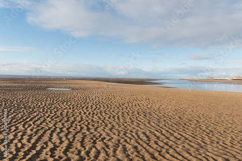 Beautiful blue sky and textured sand, on a sunny day at the beach