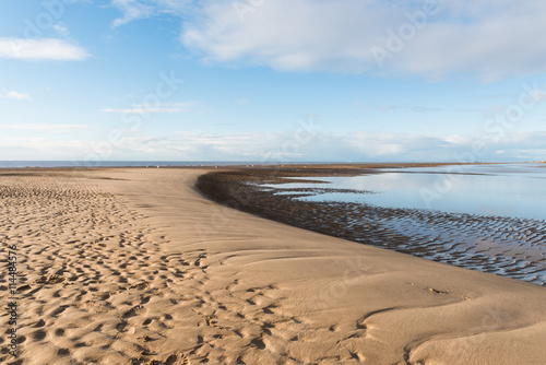 Beautiful blue sky and textured sand, on a sunny day at the beach