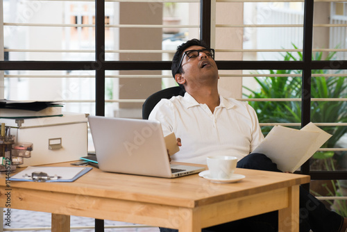 sleepy indian man  at office