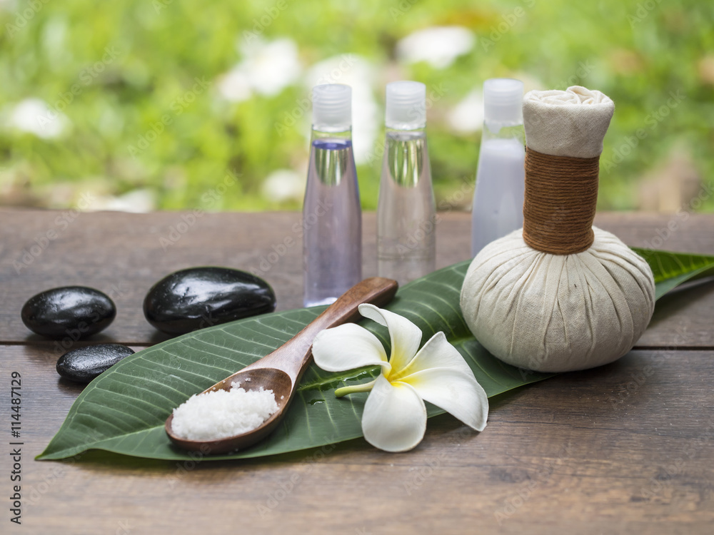 Fototapeta premium Spa massage compress balls, herbal ball on the leaves with rock spa, Thailand, select focus 