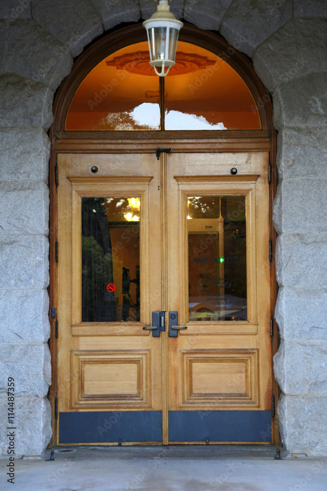 Fototapeta premium Classic stained wood door with hanging light