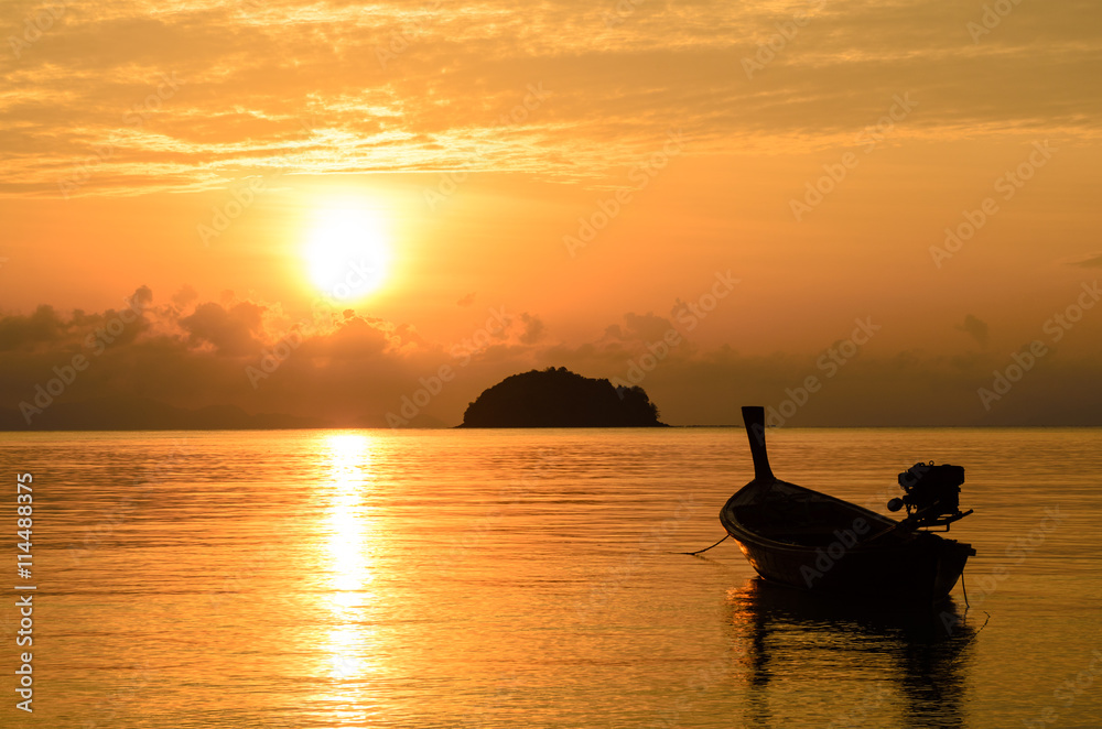 Silhouette of fishing boat in sunrise sky, summer time to travel.