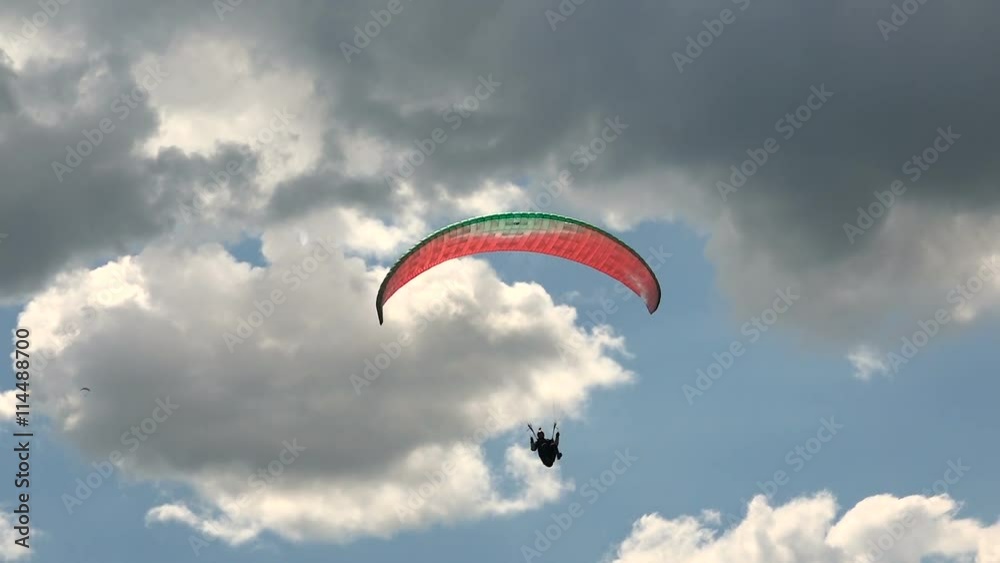 Landing of Paraglider on a Background of Cumulus Clouds Landing of Paraglider on a Background of Cumulus Clouds