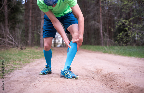 Calf leg pain, man holding sore and painful muscle, sprain or cramp. Person injured when exercising or running