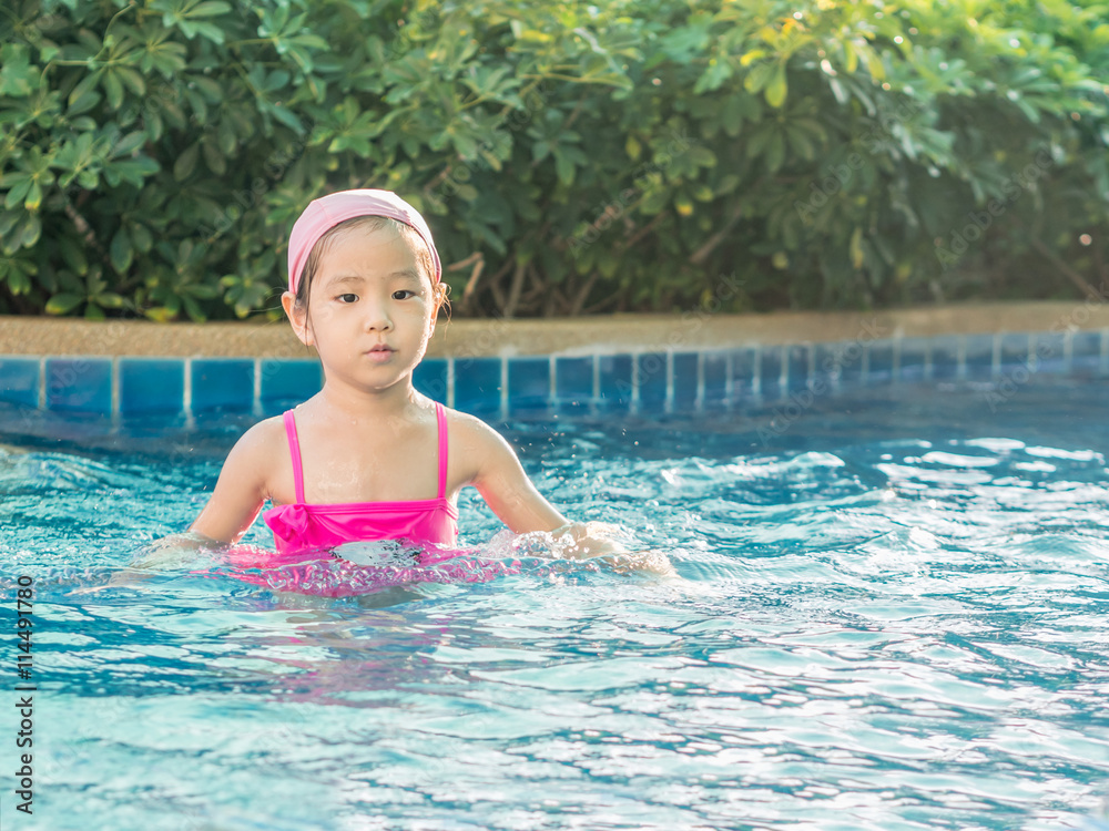 Asian girl is playing in the pool