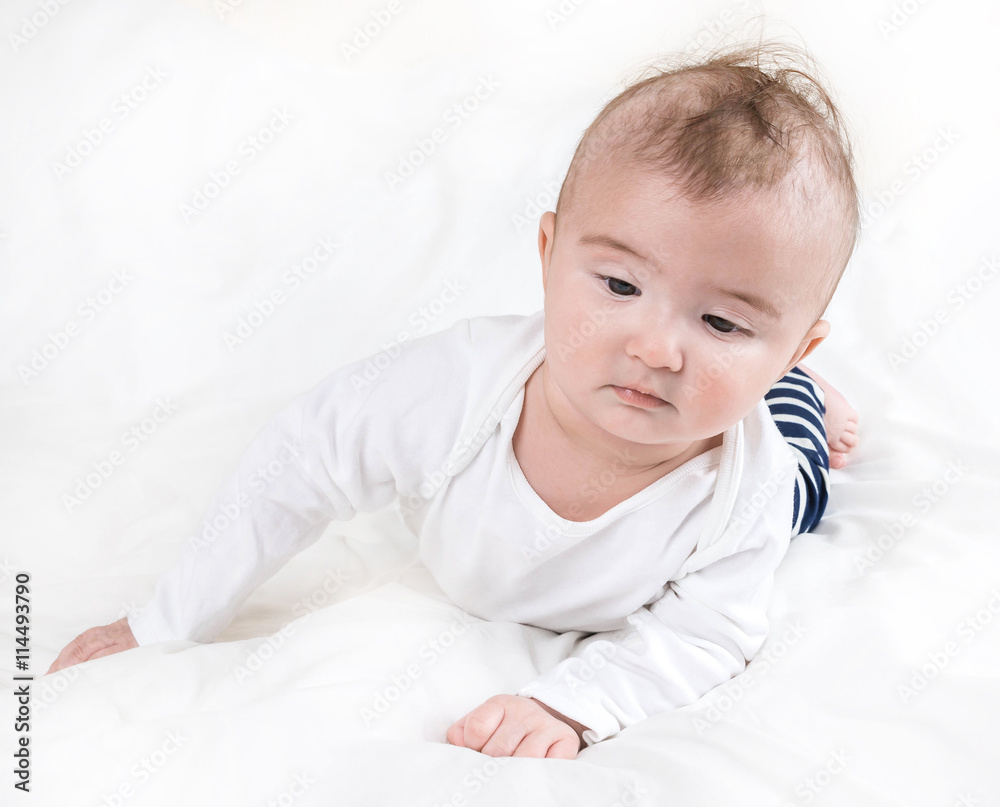 The child in bright clothes and diapers on a white background